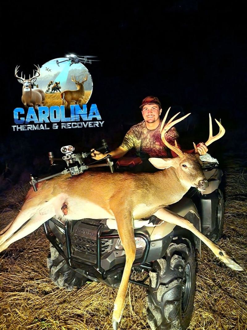 Hunter with his recovered buck on the ATV after a night search