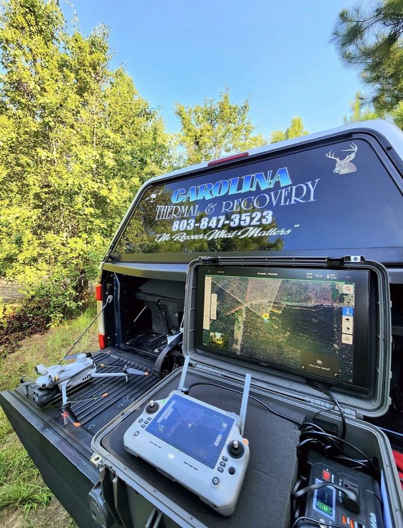 The truck with the drone and ground station set up on the tailgate